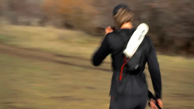 Runner moving fast through a sage hillside, motion blur