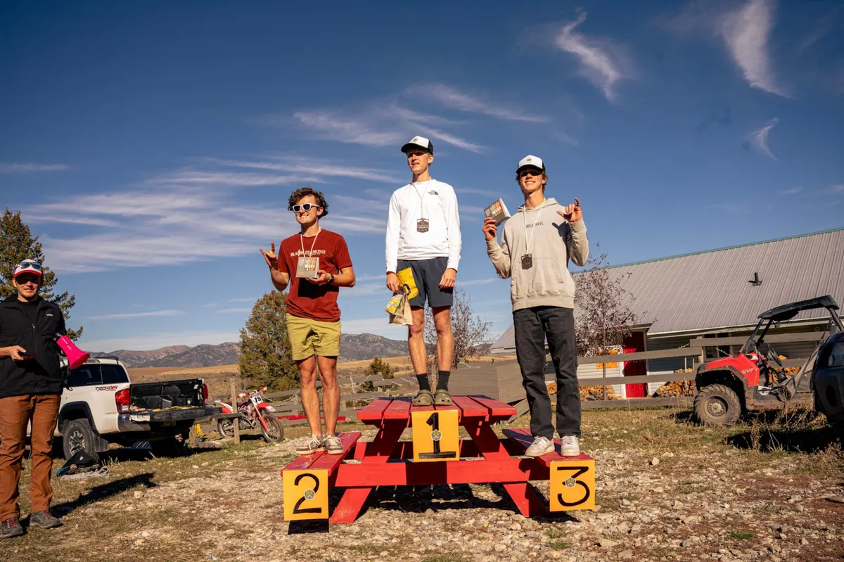 Podium winners celebrating under blue sky