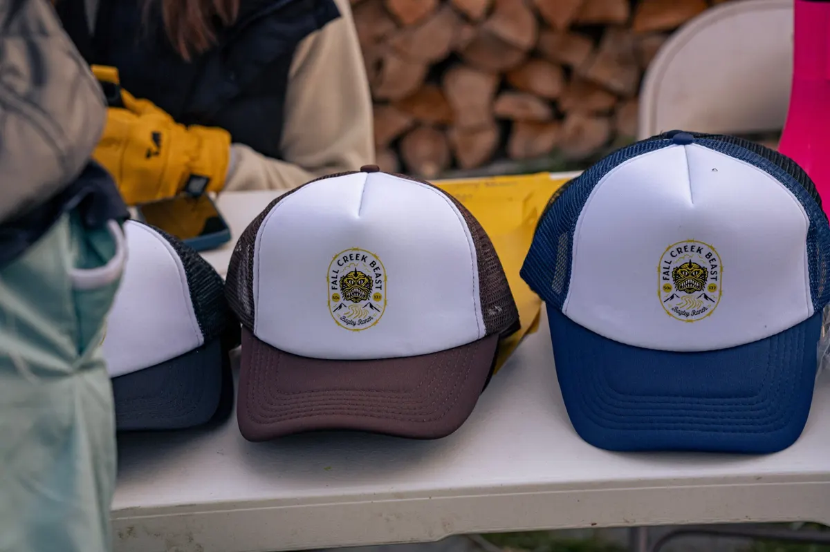 Fall Creek Beast trucker hats lined up on a table